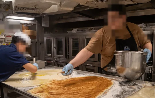 A bake shop with deck ovens and a large mixer bowl