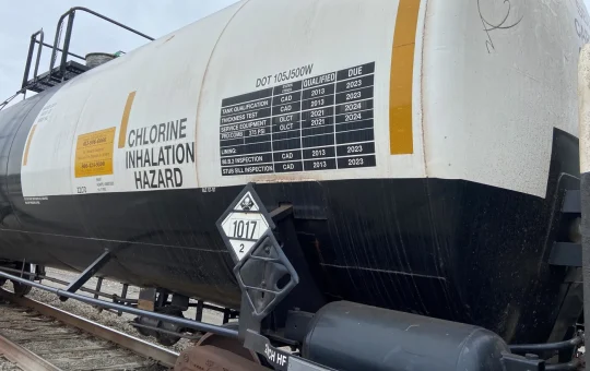A rail tank car of chlorine with a poison gas placard showing UN 1017 and an inhalation hazard marking