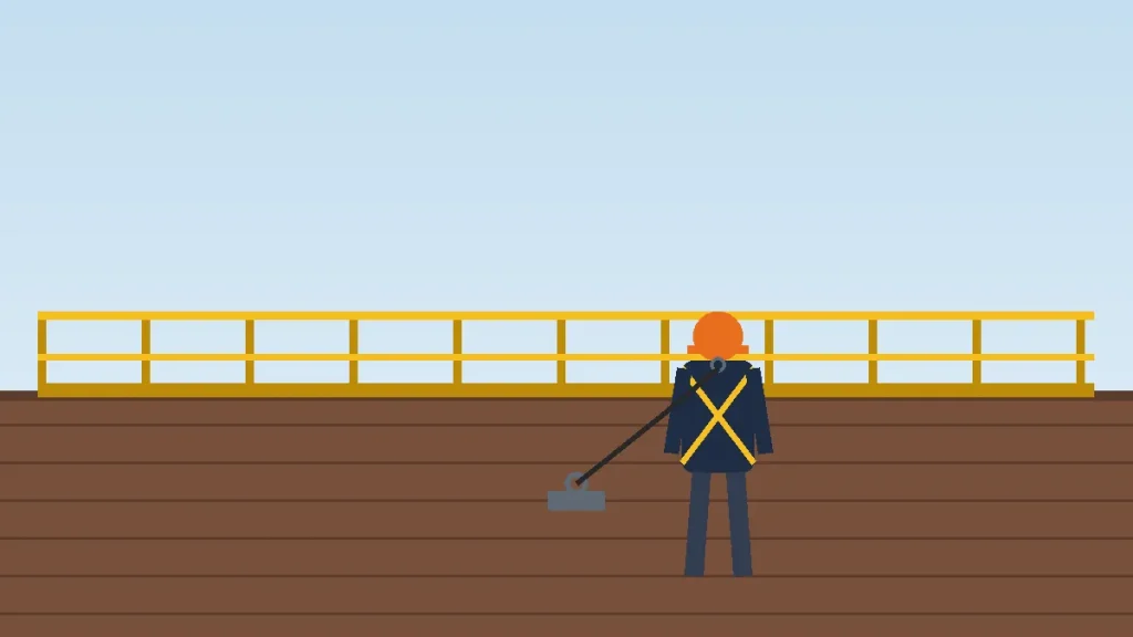 Roofer in a harness tied off to a roof anchor next to a guardrail at the roof edge